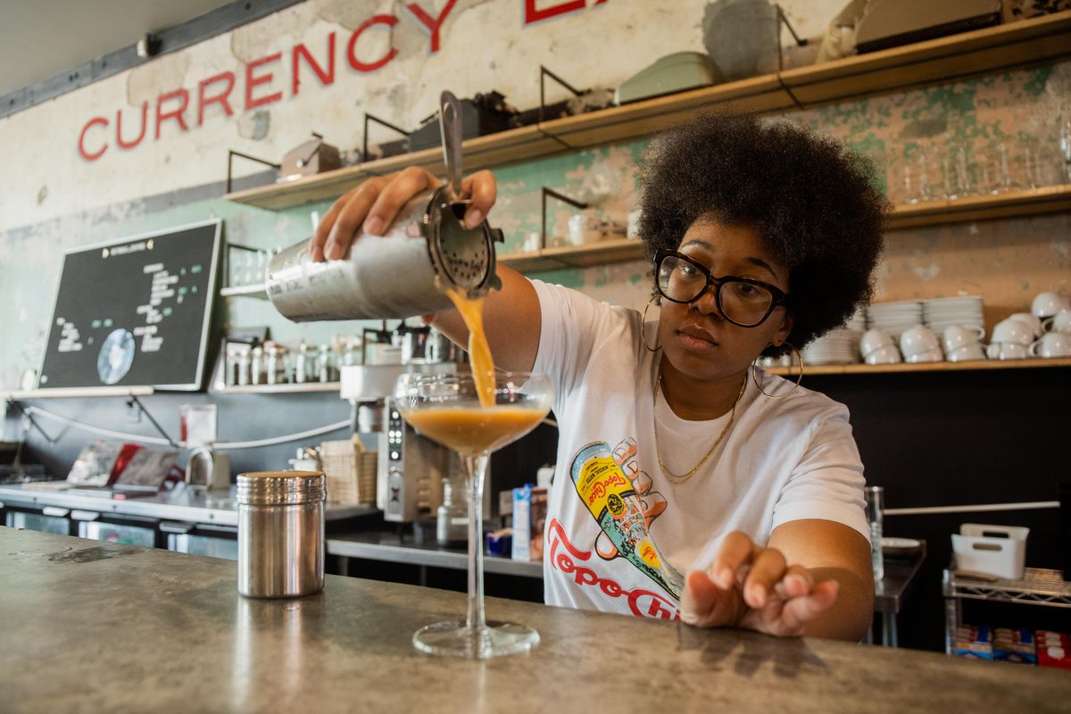 Amanda Harth, co-founder of Monday Coffee Company, prepares a drink at Retreat at Currency Exchange Café, located at 305 E. Garfield Blvd. 
