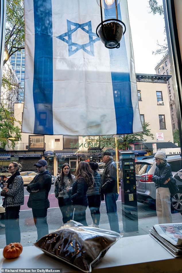 Dahan proudly displayed the Israeli flag in his coffee shop window on Wednesday