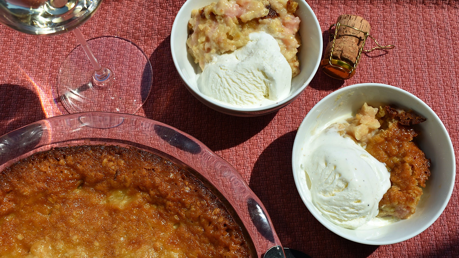  Rhubarb tart in a glass dish and bowls of tart and ice cream