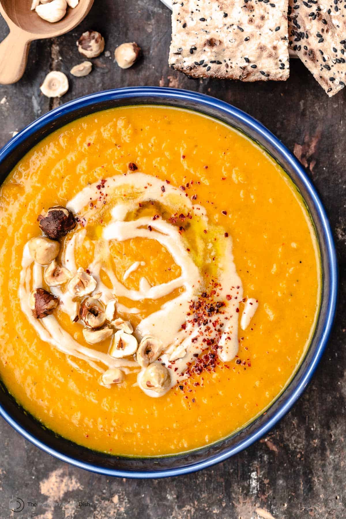 A bowl of roasted butternut squash soup with tahini and honey